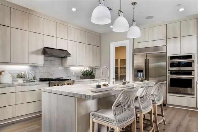a kitchen with a sink cabinets and refrigerator