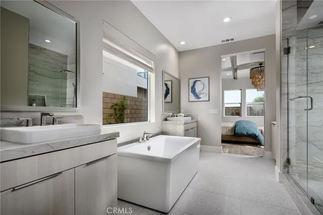 a en suite bathroom with a double vanity sink a mirror and a shower