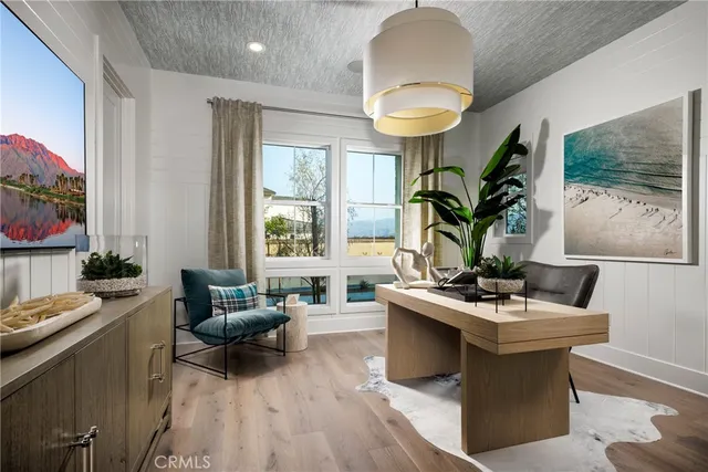 a living room with furniture a flat screen tv and a large window