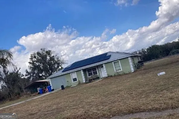 a front view of house with sign board