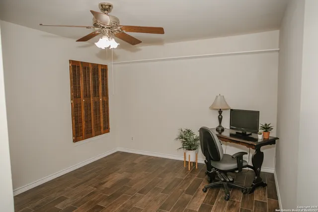 a workspace with wooden floor and a window