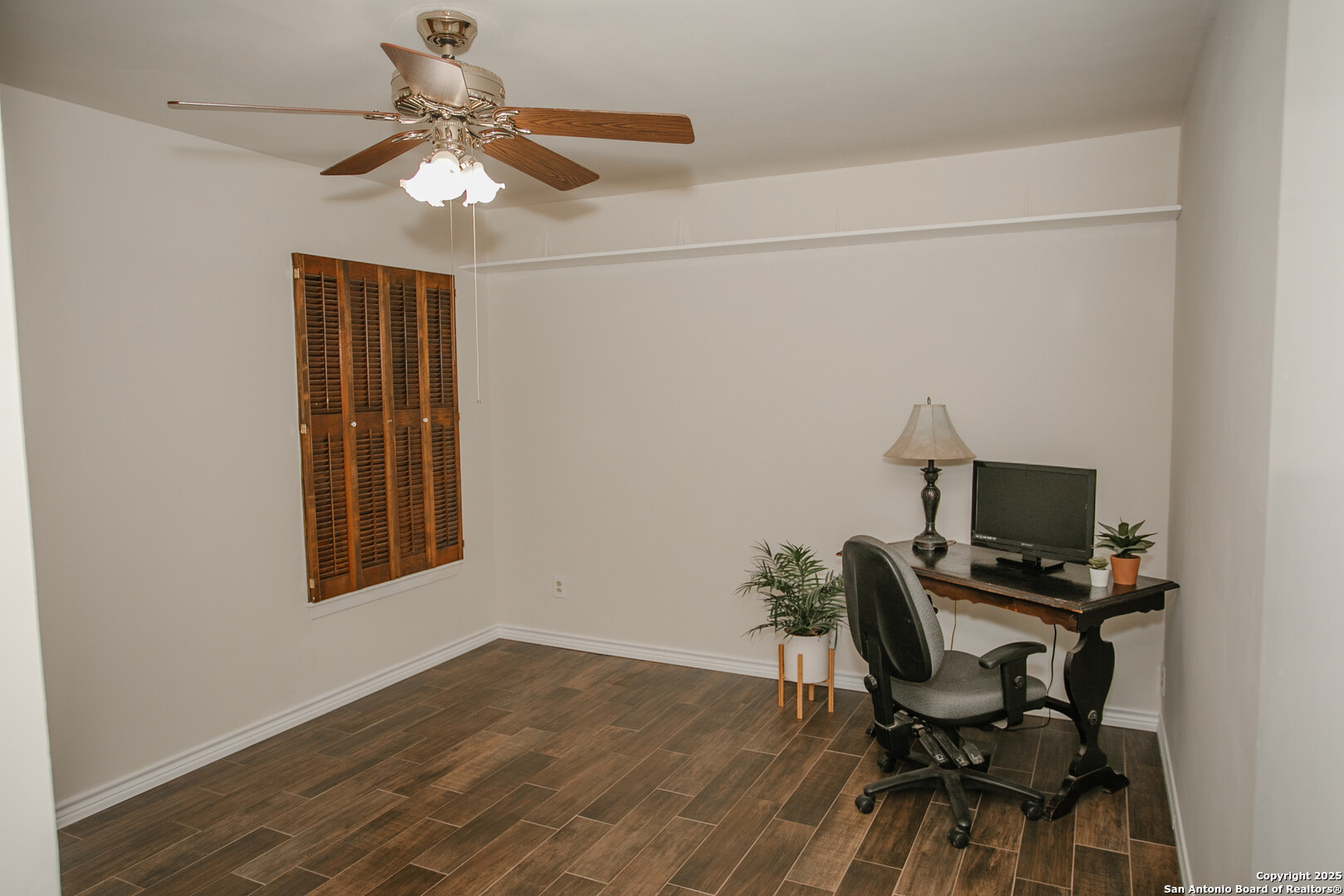 456 Margo Drive Pearsall, TX 78061 - Photo 12 of 40 a workspace with wooden floor and a window