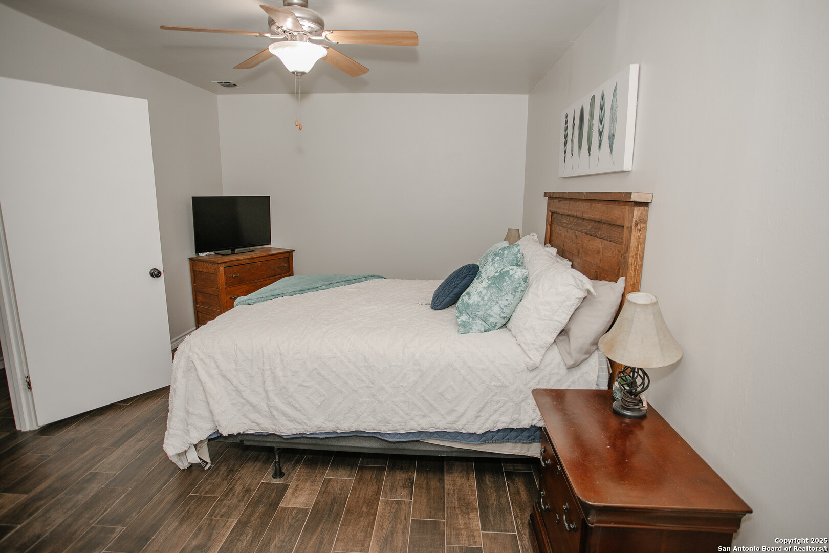456 Margo Drive Pearsall, TX 78061 - Photo 15 of 40 a bedroom with a bed and wooden floor