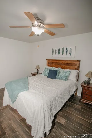 a bedroom with a bed and wooden floor