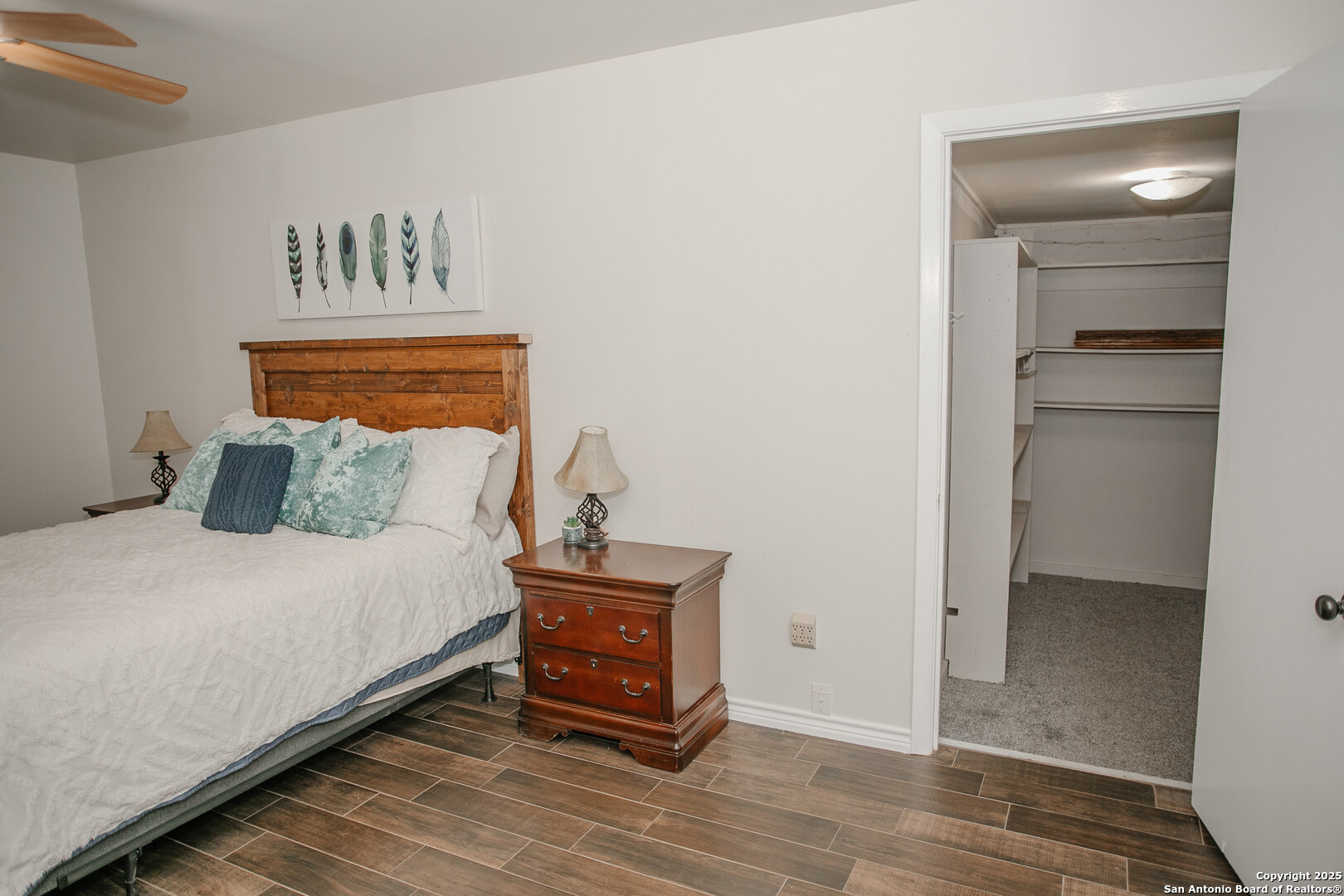 456 Margo Drive Pearsall, TX 78061 - Photo 17 of 40 a bedroom with a bed and a painting on the wall