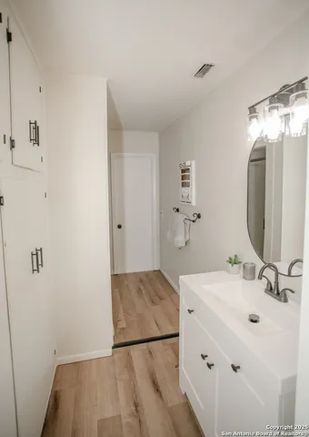 a bathroom with a sink and mirror