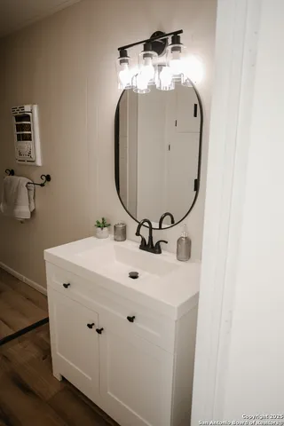 a bathroom with a sink and mirror