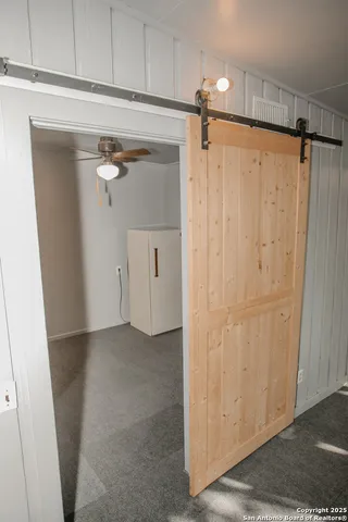 a view of a closet with wooden floor