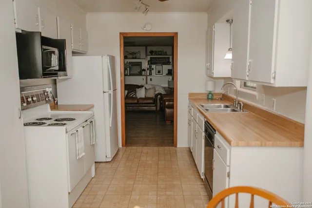 a kitchen with a sink stove and refrigerator
