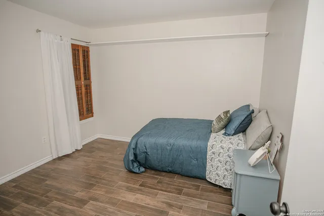 a bed room with a bed and a window