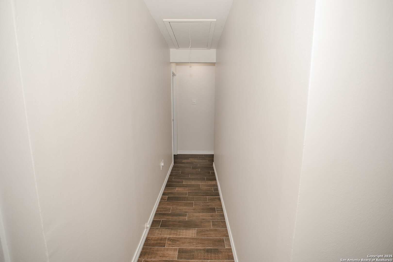 456 Margo Drive Pearsall, TX 78061 - Photo 9 of 40 a view of a hallway with wooden floor