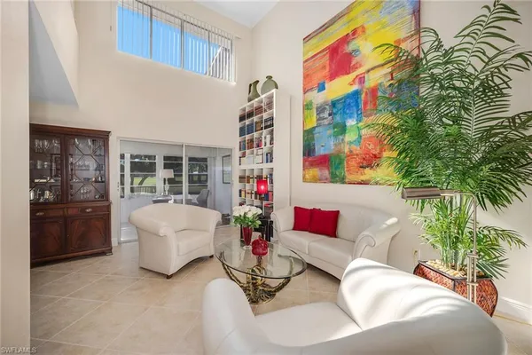 a living room with furniture and flowers
