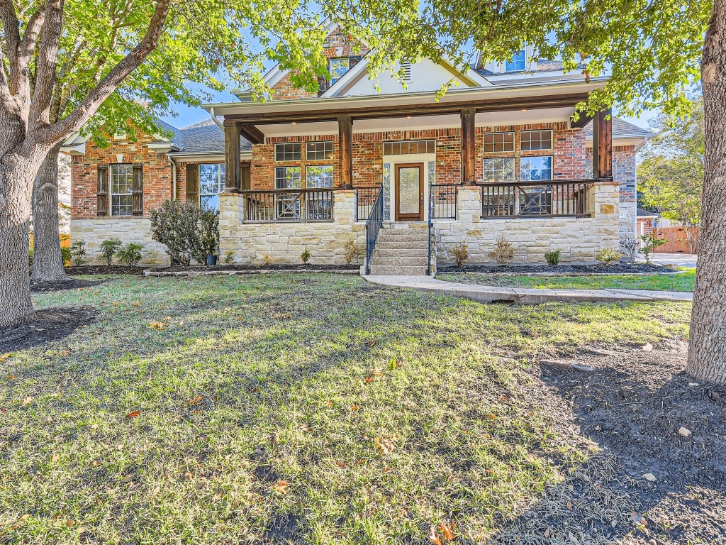 a view of a house with a yard and sitting area