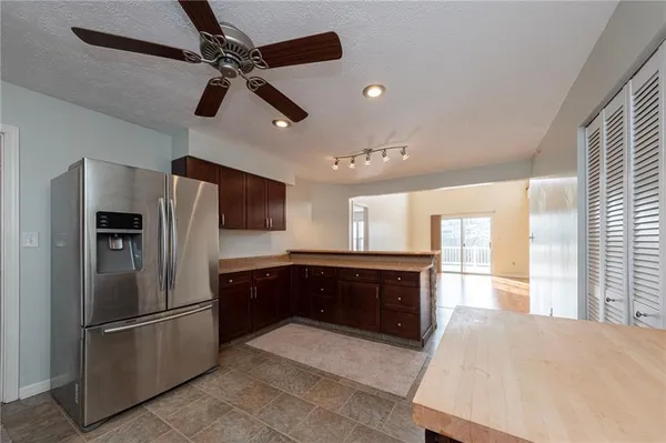 a large kitchen with a refrigerator and a sink