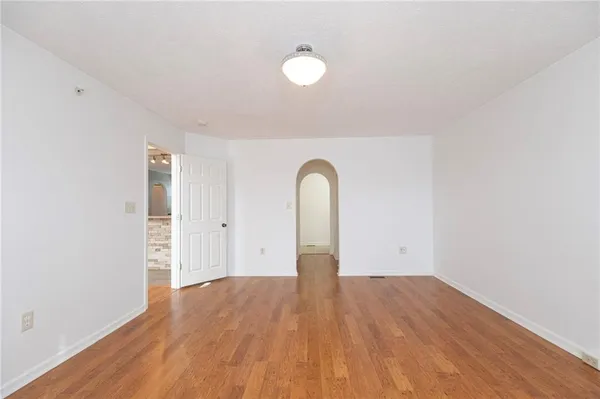 a view of a room with wooden floor and white walls