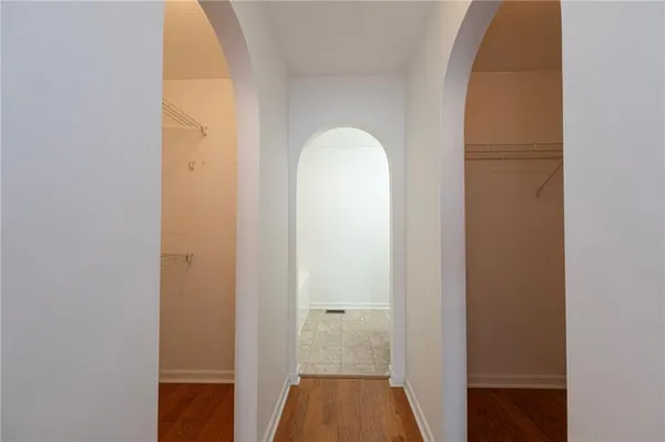 a view of a room with wooden floor