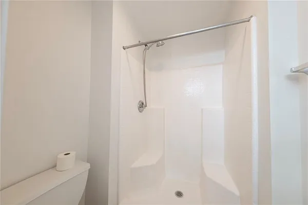 a bathroom with a shower and a toilet
