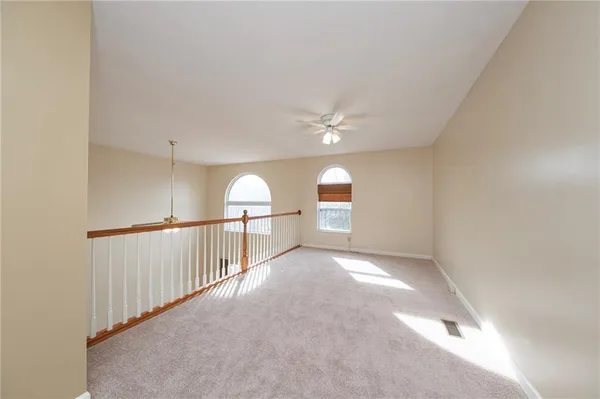 a view of a livingroom with a ceiling fan and window