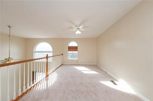 a view of a livingroom with a ceiling fan and window