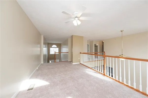 a view of a livingroom with a ceiling fan and window