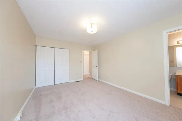 a view of an empty room and a window