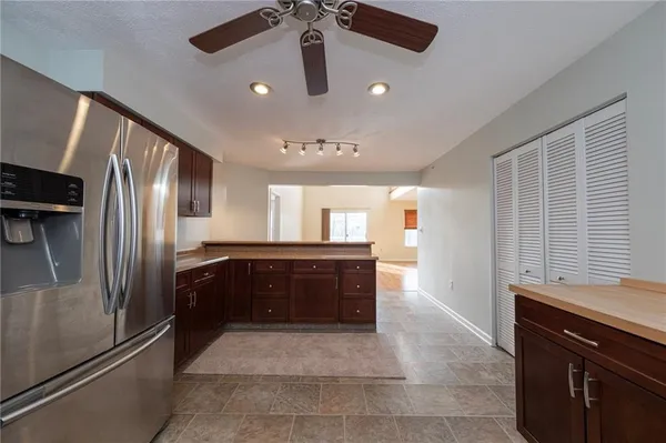 a kitchen with a refrigerator and a sink