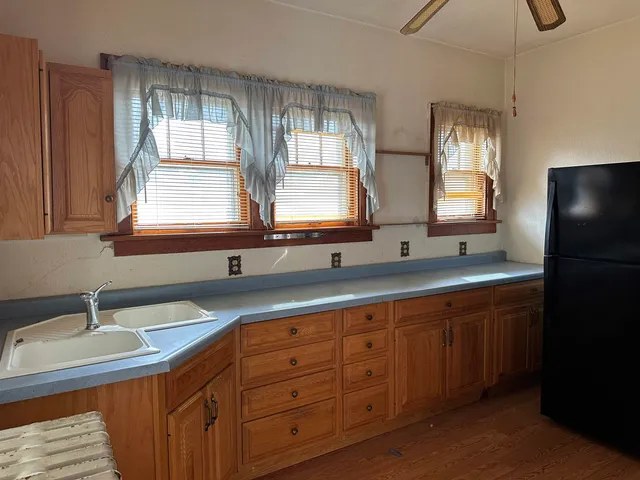 a bathroom with double vanity sink a mirror and a window
