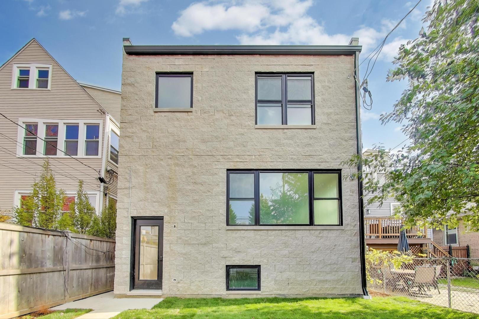 3822 North Bell Avenue Chicago, IL 60618 - Photo 4 of 8 a front view of a house with garden