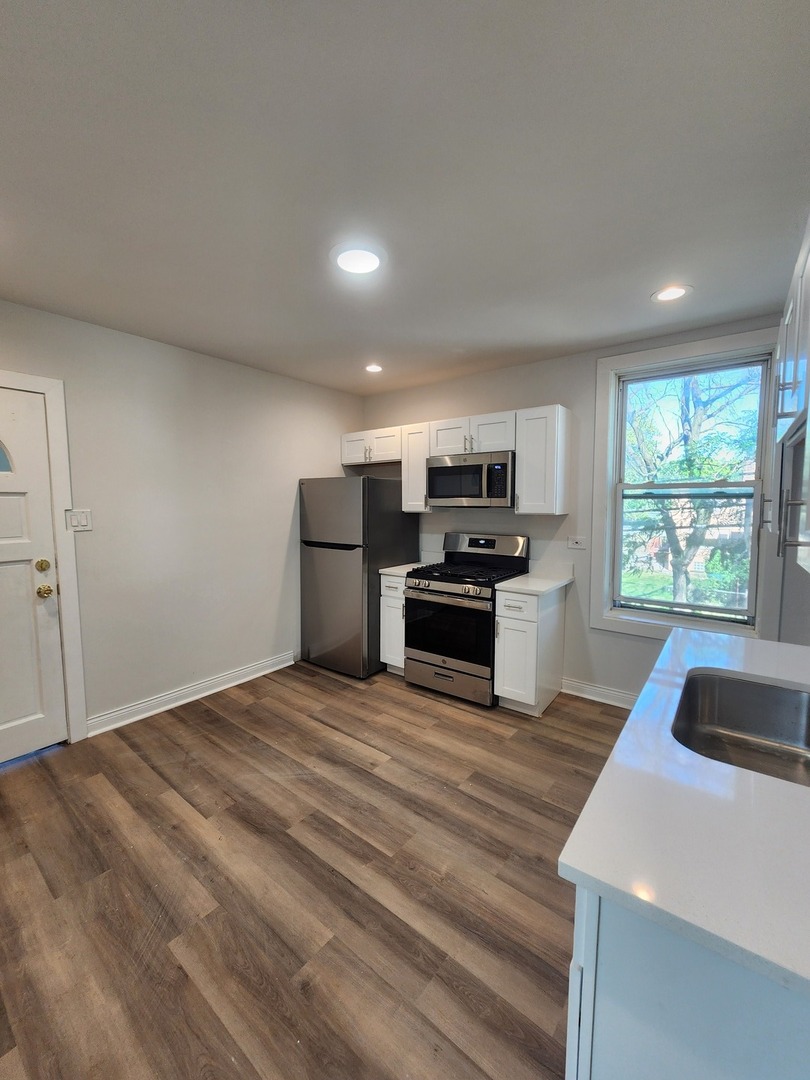 8900 South Normal Avenue Chicago, IL 60620 - Photo 11 of 28 a kitchen with granite countertop a refrigerator and a sink
