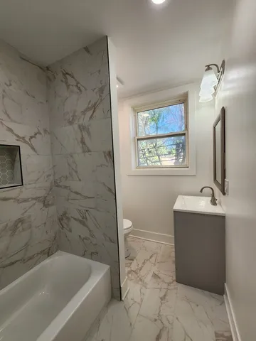 a bathroom with a bathtub and window