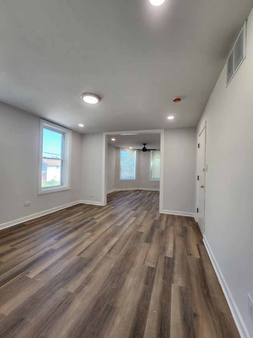 8900 South Normal Avenue Chicago, IL 60620 - Photo 16 of 28 wooden floor in an empty room with a window