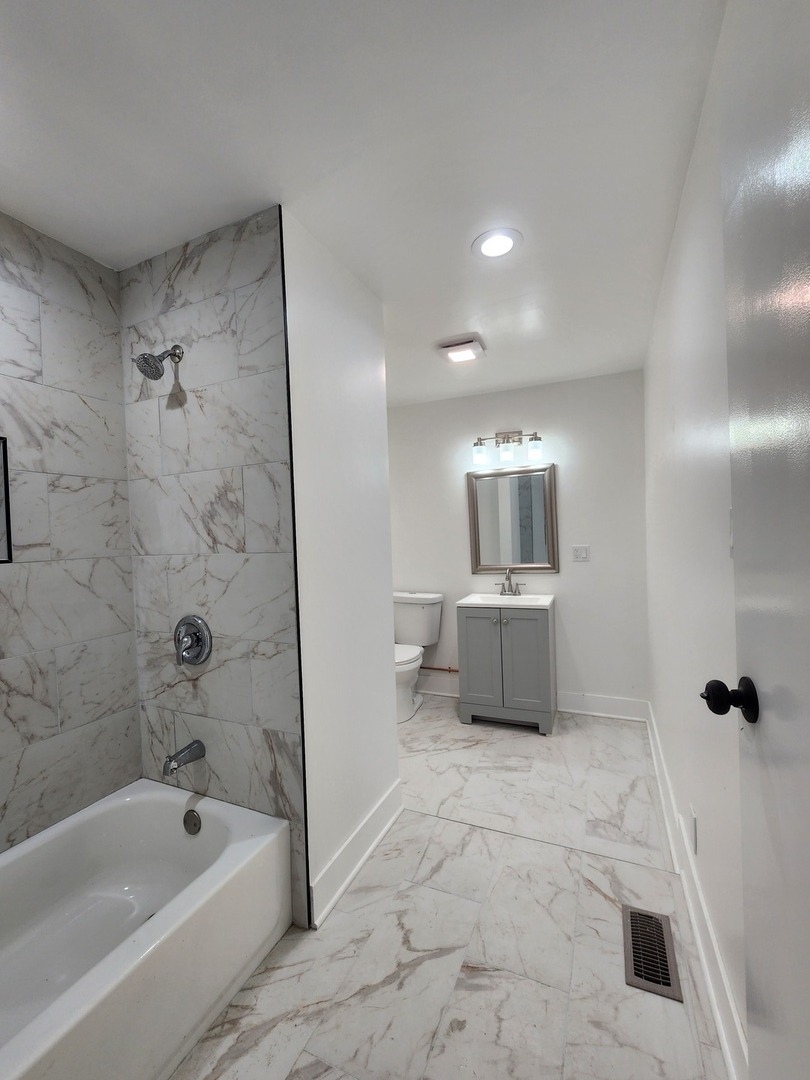 8900 South Normal Avenue Chicago, IL 60620 - Photo 7 of 28 a bathroom with a bathtub and a shower