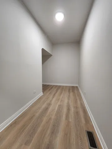 a view of room with wooden floor