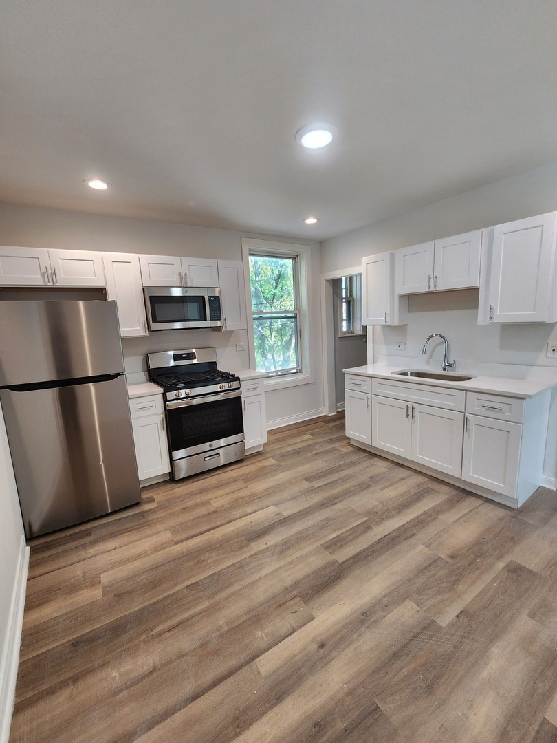 8900 South Normal Avenue Chicago, IL 60620 - Photo 10 of 28 a kitchen with stainless steel appliances a refrigerator sink and microwave