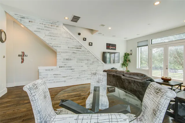 a living room with furniture a large window and a fireplace