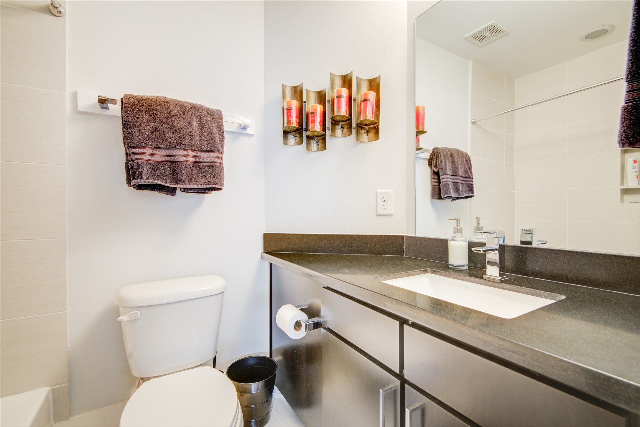 1401 Nagle Street Houston, TX 77003 - Photo 21 of 31 a bathroom with a granite countertop sink and a mirror