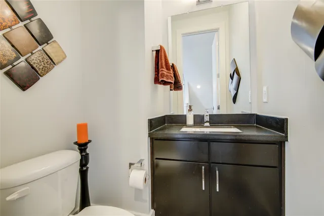 a bathroom with a sink and mirror with toilet