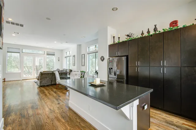 a kitchen with sink refrigerator and large window