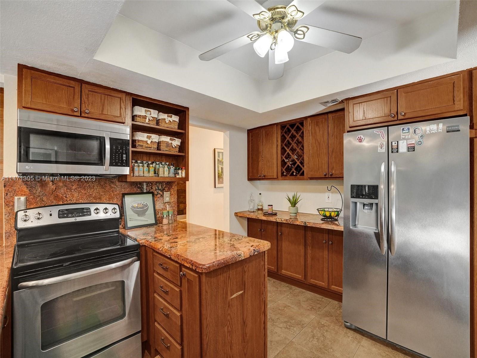 2028 South Conference Drive Boca Raton, FL 33486 - Photo 12 of 62 a kitchen with a sink stainless steel appliances and cabinets