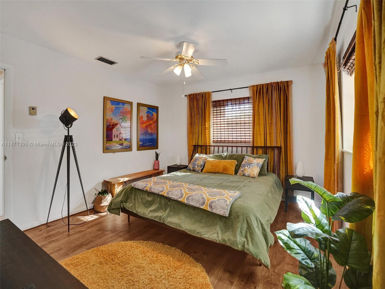 2028 South Conference Drive Boca Raton, FL 33486 - Photo 19 of 62 a bedroom with a bed and a chandelier
