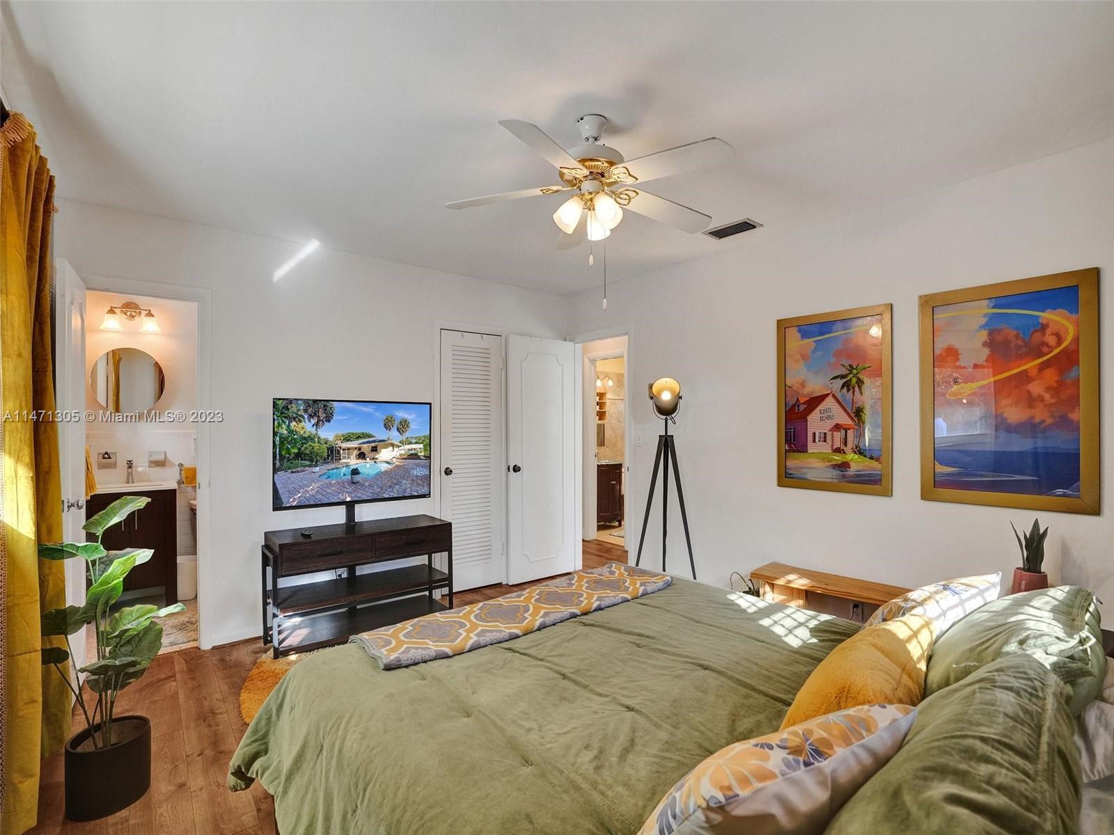 2028 South Conference Drive Boca Raton, FL 33486 - Photo 20 of 62 a bedroom with a bed and a flat screen tv