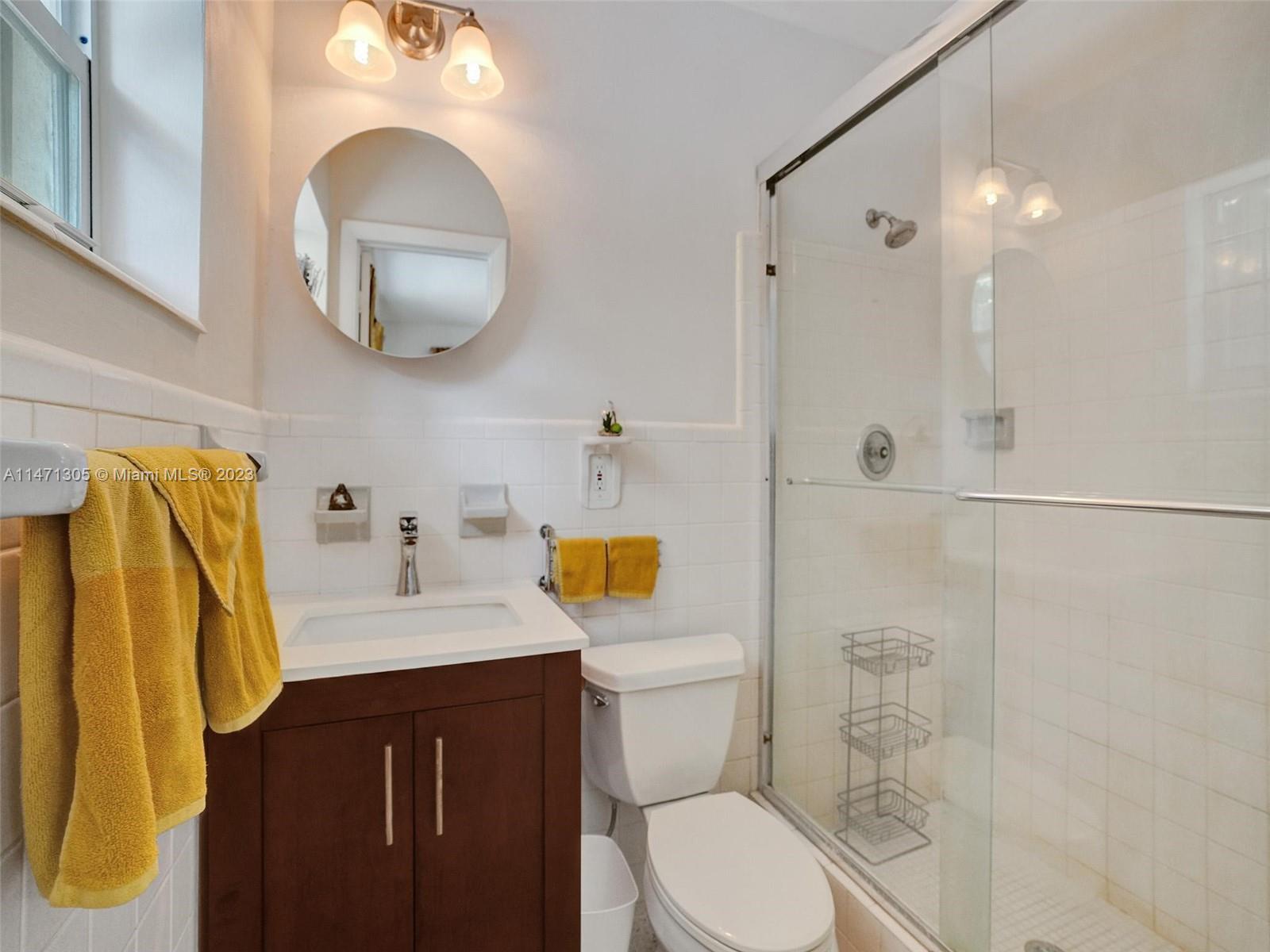 2028 South Conference Drive Boca Raton, FL 33486 - Photo 22 of 62 a bathroom with a sink vanity mirror and toilet