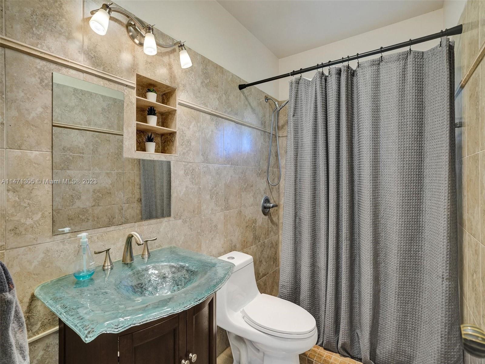 2028 South Conference Drive Boca Raton, FL 33486 - Photo 23 of 62 a bathroom with a granite countertop sink toilet and shower