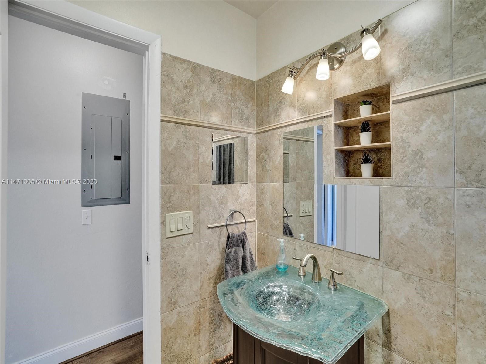 2028 South Conference Drive Boca Raton, FL 33486 - Photo 24 of 62 a bathroom with a sink and a mirror