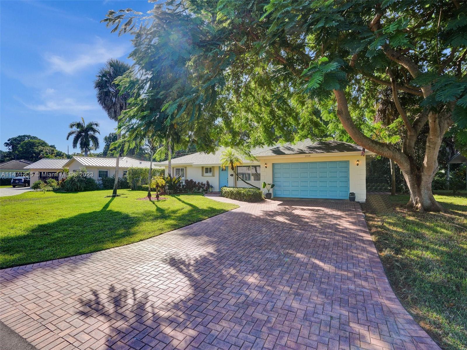 2028 South Conference Drive Boca Raton, FL 33486 - Photo 41 of 62 a front view of a house with a yard and tree