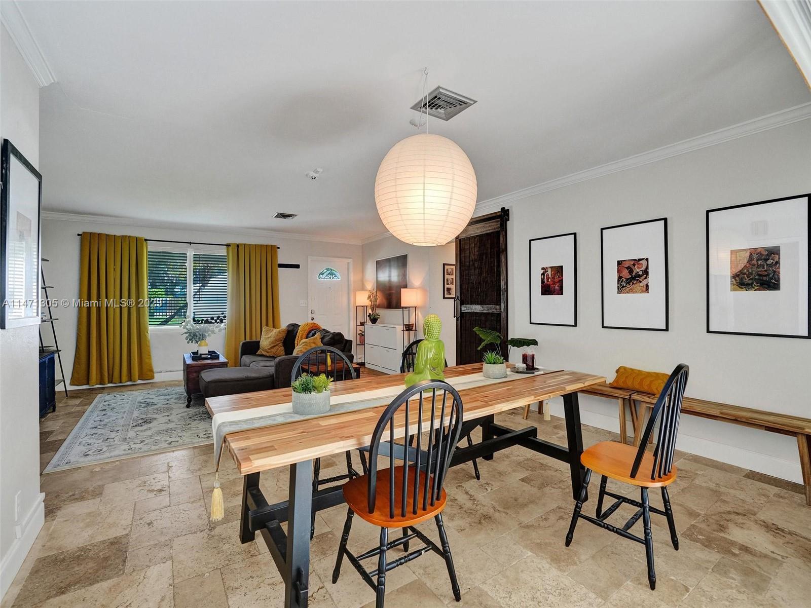 2028 South Conference Drive Boca Raton, FL 33486 - Photo 8 of 62 a view of a dining room with furniture and a chandelier