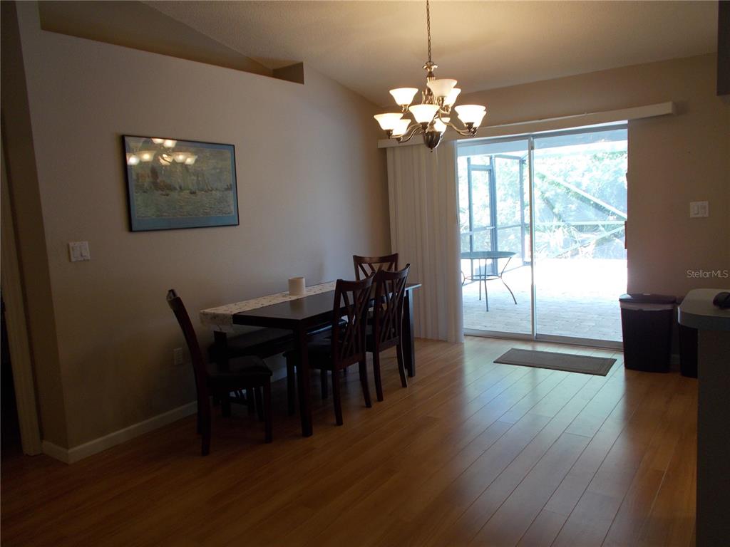 2880 Geneva Road Venice, FL 34293 - Photo 5 of 19 a view of a dining room with furniture and chandelier