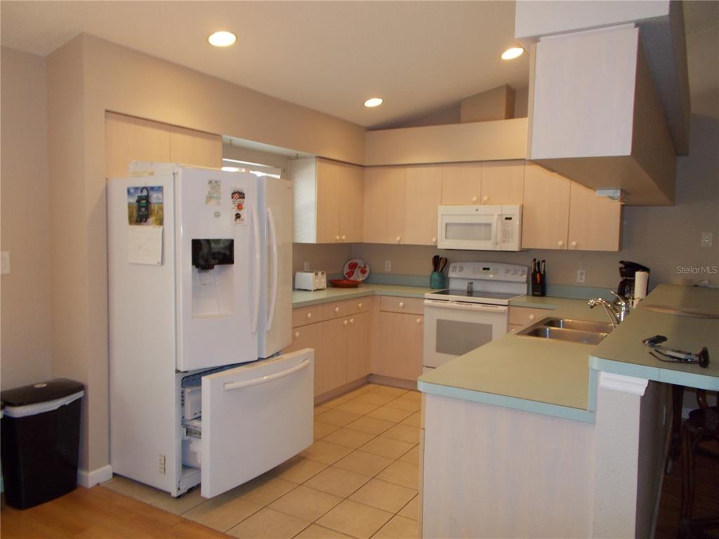 2880 Geneva Road Venice, FL 34293 - Photo 6 of 19 a kitchen with a refrigerator a stove top oven a sink and dishwasher