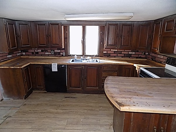 13 Basket Street Huntington, MA 01050 - Photo 5 of 18 a kitchen with wooden cabinets a sink and a stove