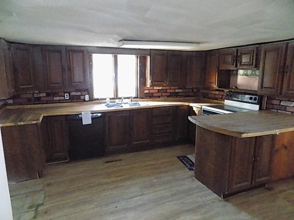 13 Basket Street Huntington, MA 01050 - Photo 6 of 18 a kitchen with stainless steel appliances granite countertop a sink stove and wooden cabinets